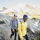 1287678994
Smiling couple hiking on alpine trail with Mt Rainier in background