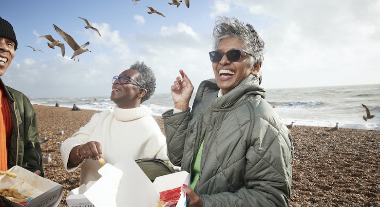 Cheerful male and female friends having french fries at beach on sunny day
1356178617
Three friends on Brighton beach, laughing and eating chips while seagulls circle them