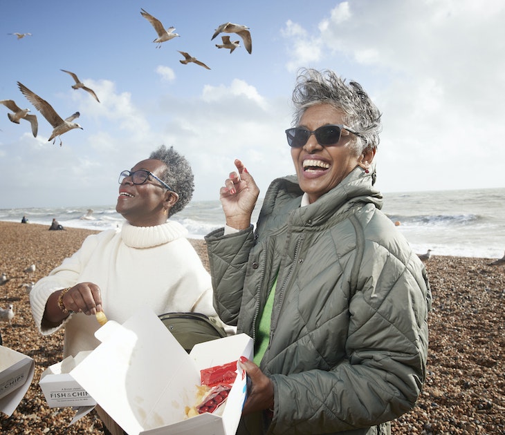 Cheerful male and female friends having french fries at beach on sunny day
1356178617
Three friends on Brighton beach, laughing and eating chips while seagulls circle them