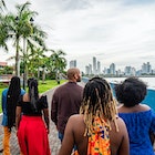 Rear View Following a Group of Cheerful, Fashionable Afro-Descendant Black Tourists Walking Together Taking in a View of Panama City, Panama from Plaza V Centenario with Copy Space
1426692017
A group of travelers on a walking tour of Panama City