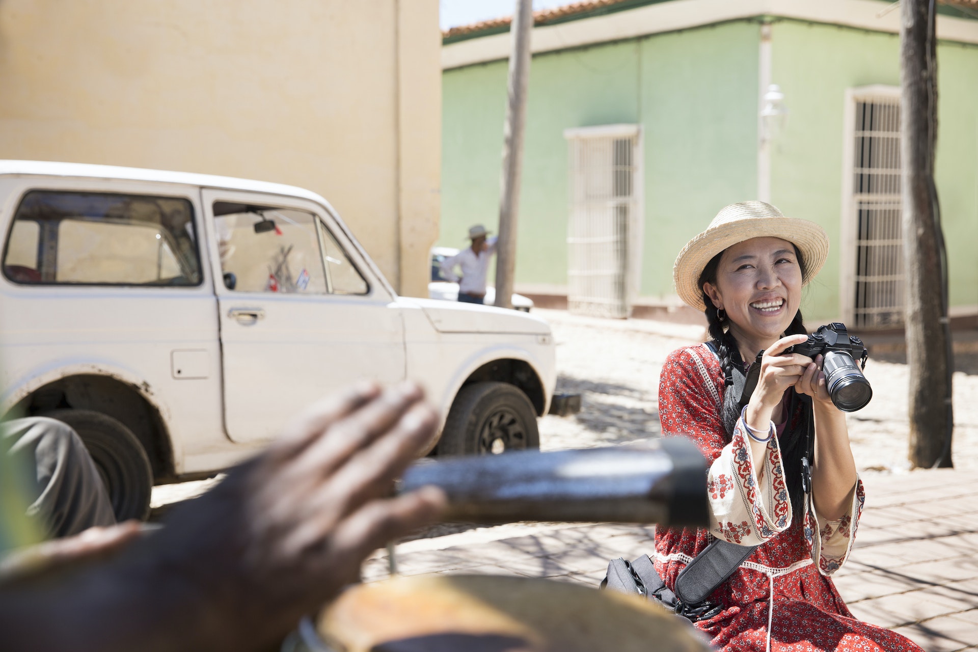 Woman with camera in a candid shot in Trinidad, Cuba