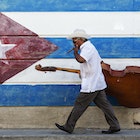 573064785
50-54 years, bass, carrying, cello, cigar, color image, Cuba, cuban flag, day, flag, full length, hat, horizontal, latin american and hispanic ethnicity, lifestyle, looking down, man, mature adult, mature men, motion, mural, music, musician, one person, outdoors, patriotism, people, photography, Santiago, Santiago de Cuba, side view, sidewalk, smoking, striped, sunglasses, travel, travel destinations, upright bass, urban, walking