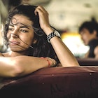 A young woman looking out of the window on a bus in Central America