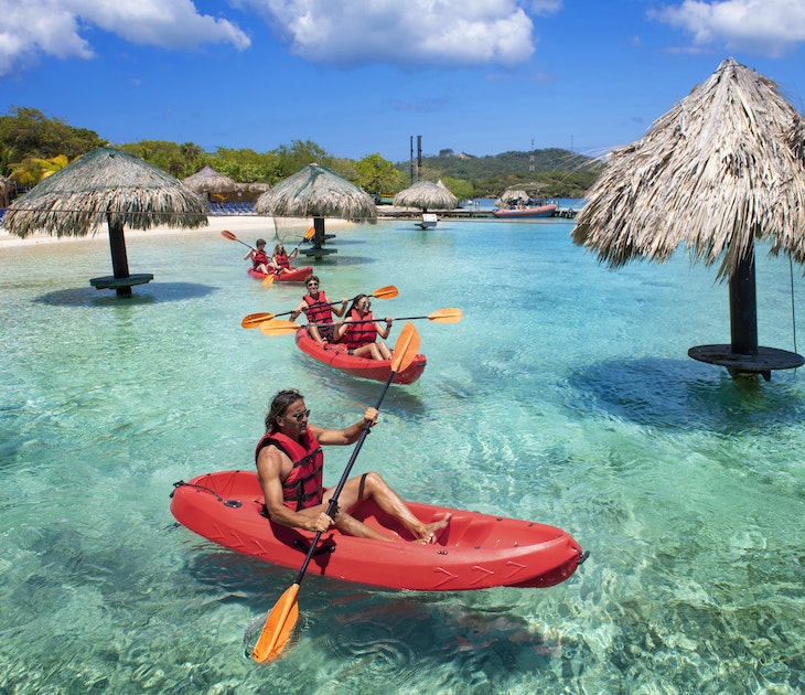 People kayaking near the beach in Roatan, Honduras