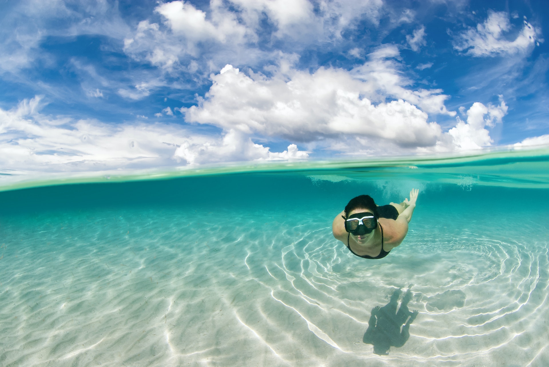 Woman snorkeling in the Caribbean waters of Roatán island