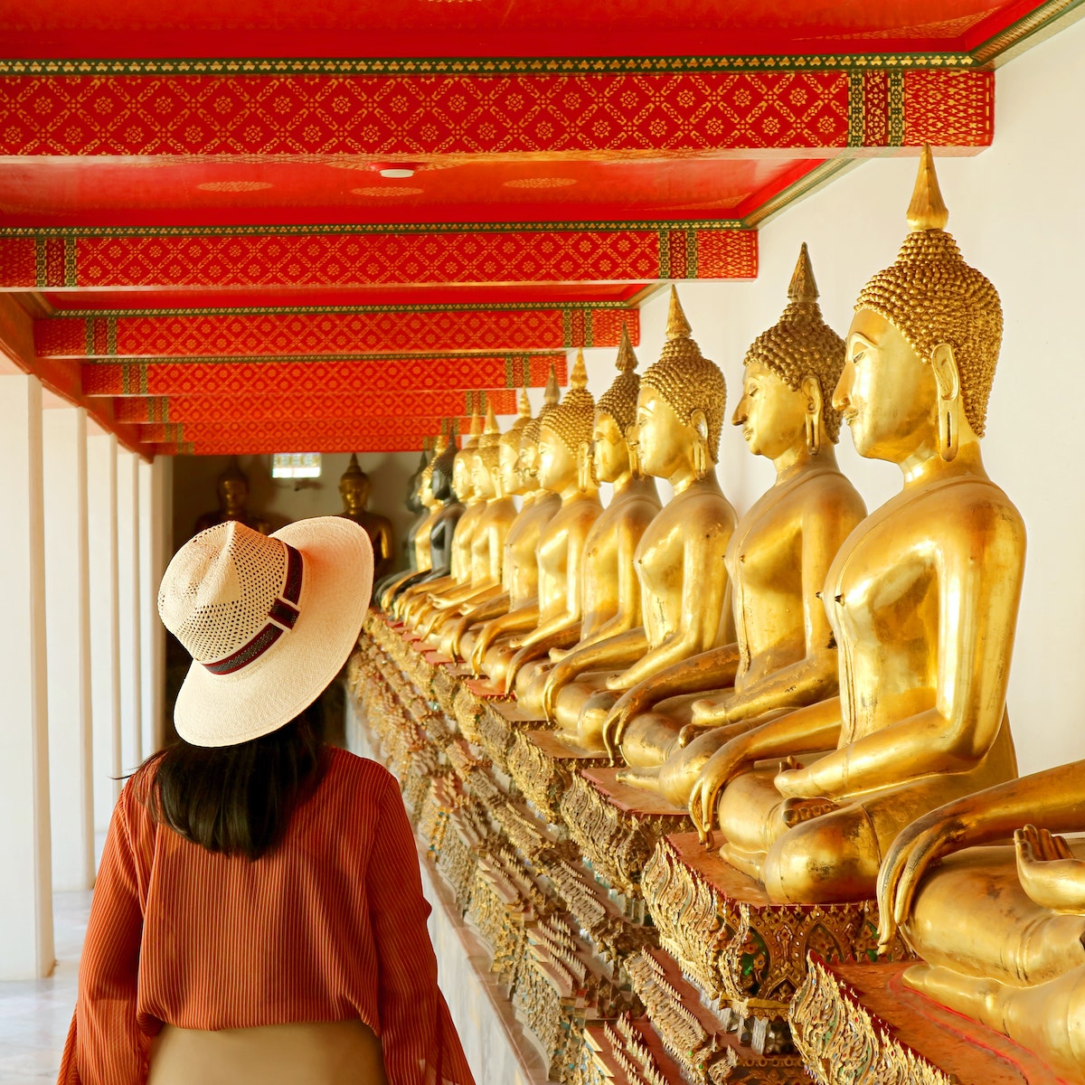 Female Visiting the Cloister with Large Group of Seated Buddha Images in Wat Pho or Temple of the Reclining Buddha, Bangkok Old City, Thailand, ( Self Portrait )