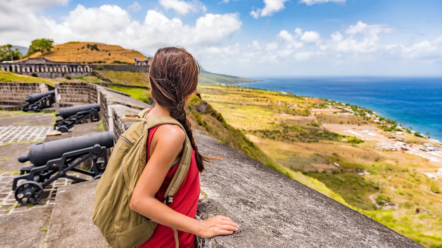 Tourist girl on St Kitts island cruise travel destination visiting Brimstone Hill Fortress National Park on vacation. Caribbean cruise ship woman walking on cannon lookout on summer holidays.
708875509