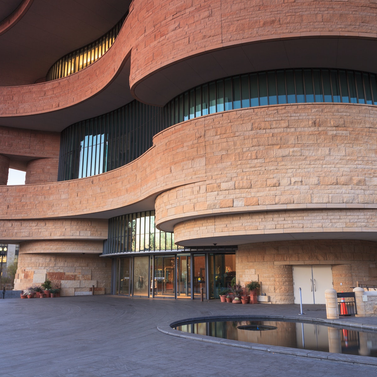 WASHINGTON, DC - NOVEMBER 30:  The entrance to the National Museum of the American Indian, as seen November 30, 2013, showcases the unusual curved architecture of the stone building.; Shutterstock ID 166031348; Your name (First / Last): Josh Vogel; Project no. or GL code: 56530; Network activity no. or Cost Centre: Online-Design; Product or Project: 65050/7529/Josh Vogel/LP.com Destination Galleries