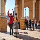 Tourists enjoy street flamenco traditional show, performance for spectators visitors at Plaza de Espana