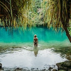 Young woman standing in the Blue Lagoon in Jamaica.