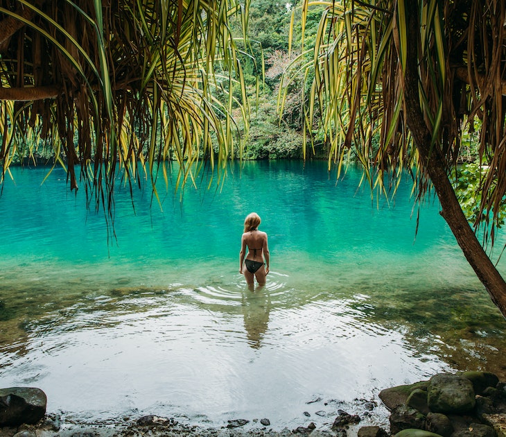 Young woman standing in the Blue Lagoon in Jamaica.