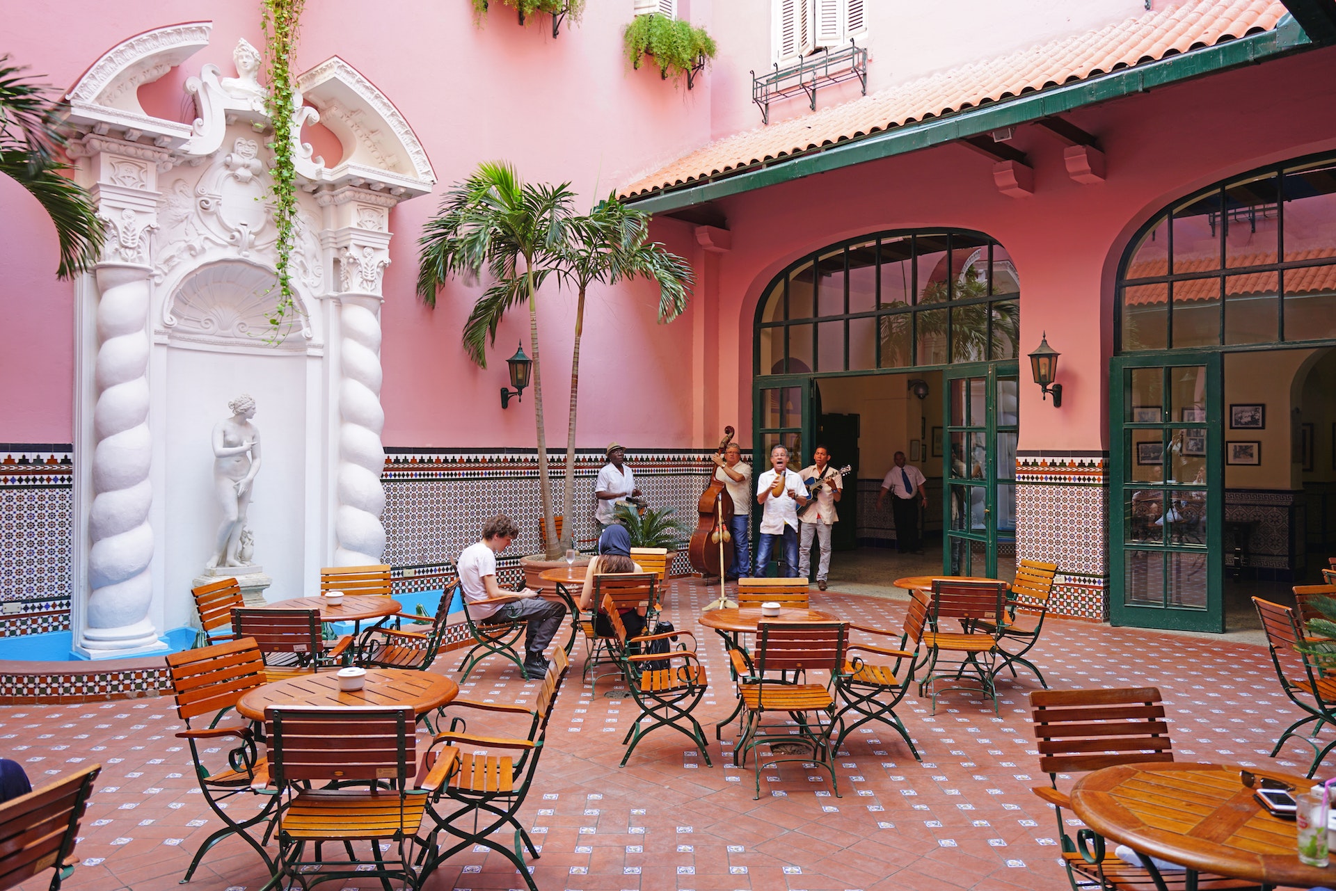 Musicians perform in the pink-tiled courtyard of the landmark Hotel Sevilla in Havana