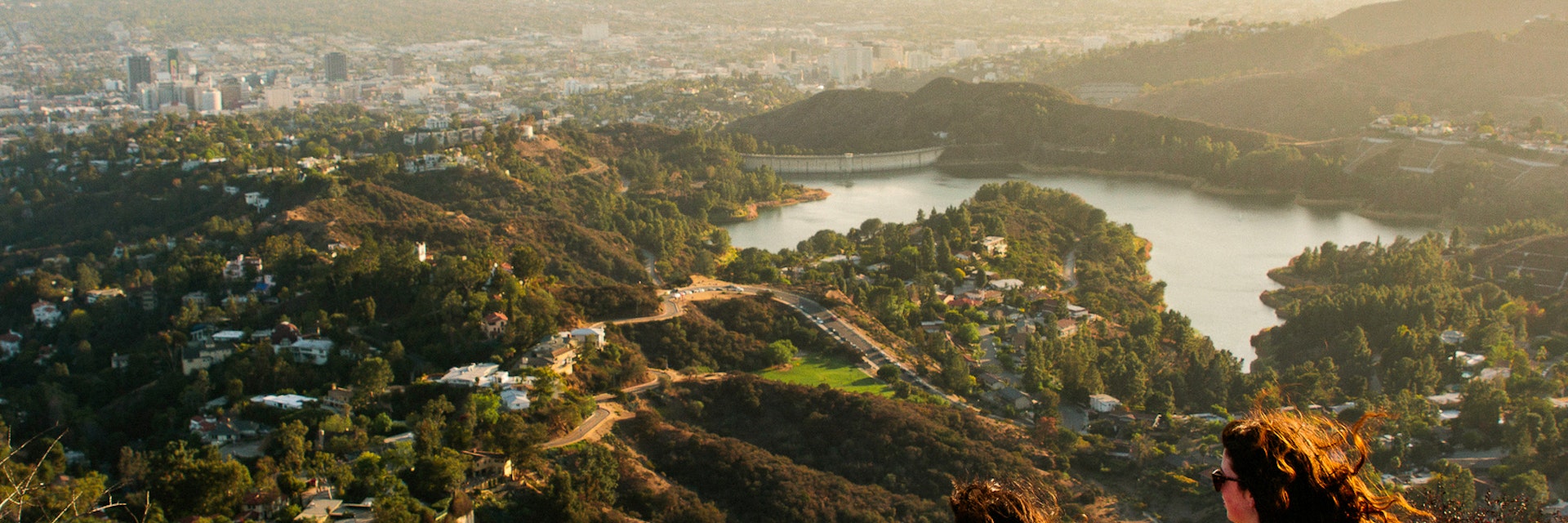 Two woman looking out over the Los Angeles skyline.