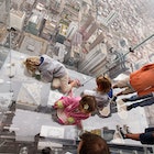 CHICAGO - JULY 01:  Children check out the view from the Ledge, a new glass cube that juts out from the 103rd floor Skydeck of the Sears Tower, during a media preview July 1, 2009 in Chicago, Illinois. The 1,353 foot high observatory will open to the public tomorrow.  (Photo by Scott Olson/Getty Images)