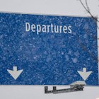 A "Departures" sign during a snow storm at Seattle-Tacoma International Airport (SEA) in Seattle, Washington, US, on Tuesday, Dec. 20, 2022. An estimated 112.7 million people will travel 50 miles or more from Dec. 23 to Jan. 2, up by 3.6 million from last