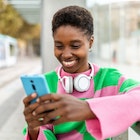 Happy young trendy african woman using mobile phone while waiting for the train at outdoors station
1439709091